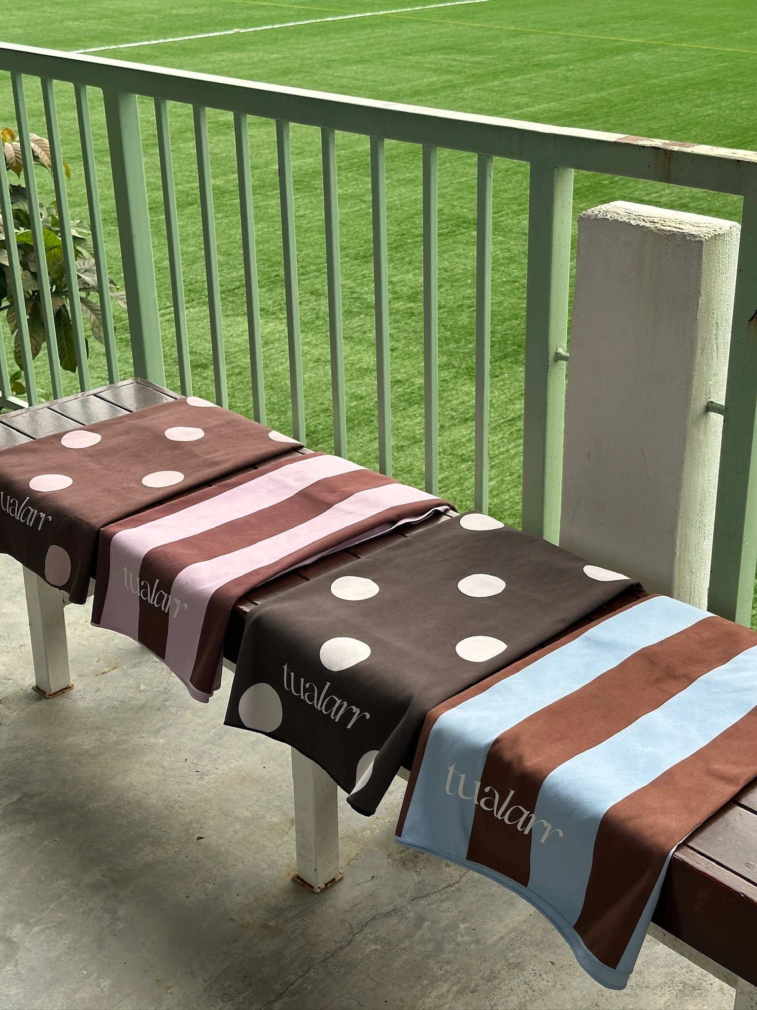 Four Tualarr towels laid across a bench